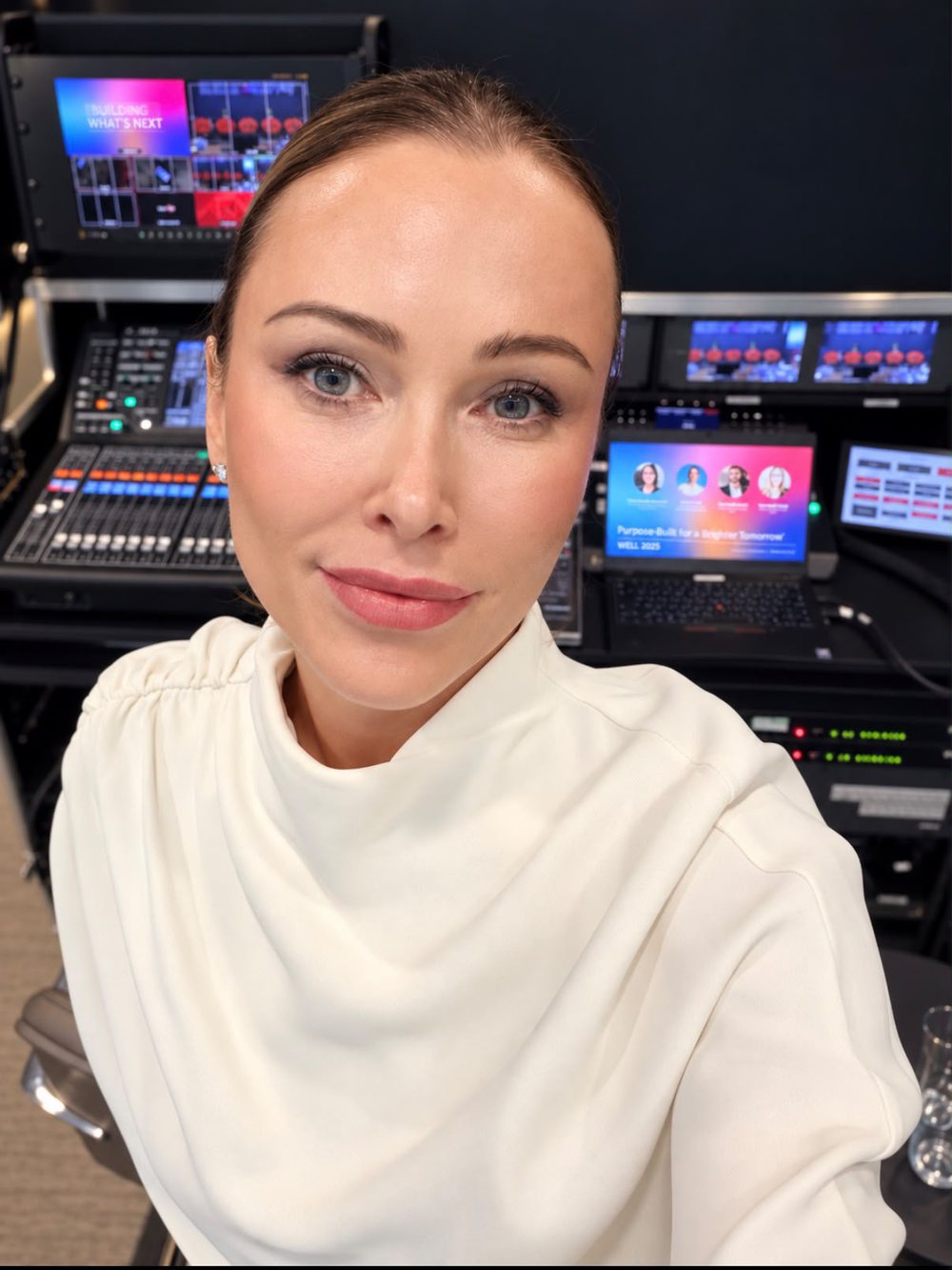 Kas Bordier at the production desk at the WELL 2026 London Summit, facing the camera
