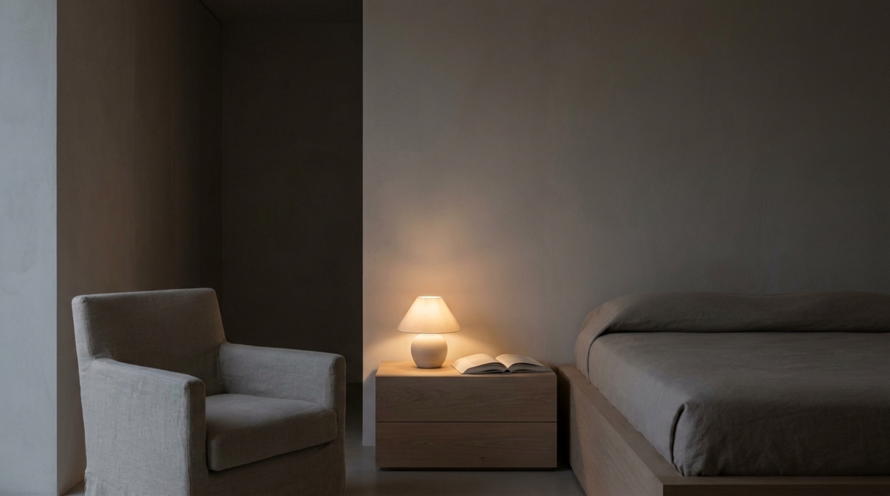 A bedroom by lamplight at night